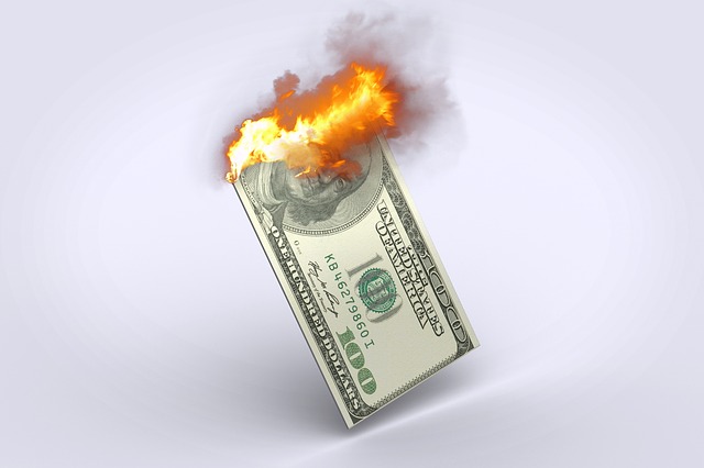 image shows burning dollar bill